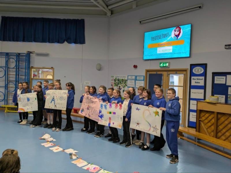Primary school pupils holding colourful banners they made during a Positive Pants wellbeing workshop