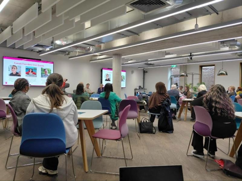 Adults at tables during a workplace wellbeing session